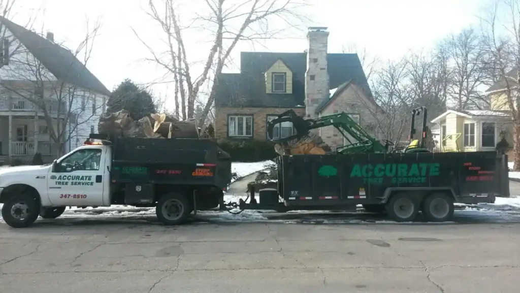 Accurate Tree Services truck hauling out equipment to a residential property